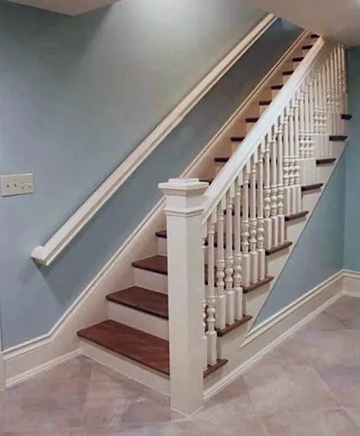 A staircase with turned balusters and a paneled soffit